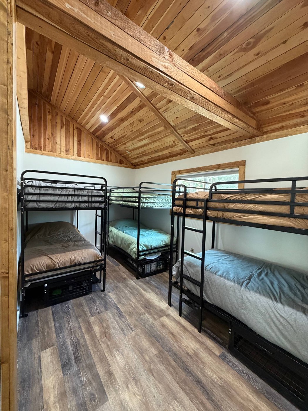 Bunk beds with linens made up in a shared bunkroom at the Wallowa Lake Pack Station bunkhouse